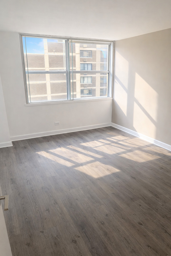 6301 North Sheridan Road, Unit 11C Chicago, IL 60660 - Photo 11 of 19 a view of an empty room with a window