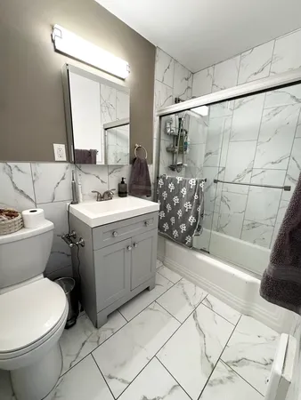 a bathroom with a sink toilet and shower