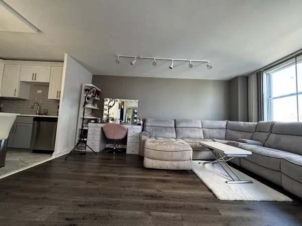 a living room with furniture and a wooden floor