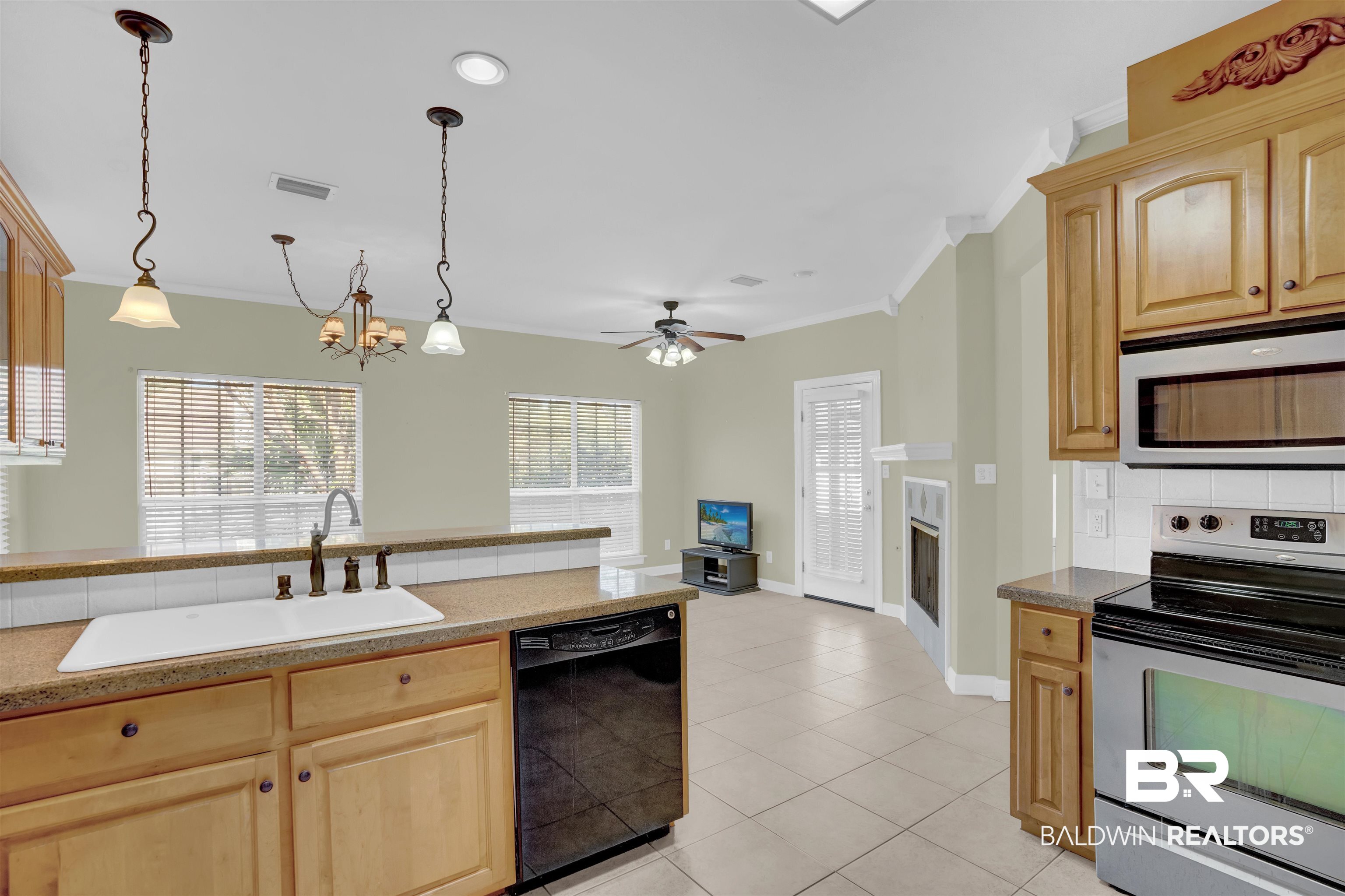 100 Conti Court Fairhope, AL 36532 - Photo 24 of 54 Kitchen with sink, hanging light fixtures, black dishwasher, electric stove, and ceiling fan with notable chandelier