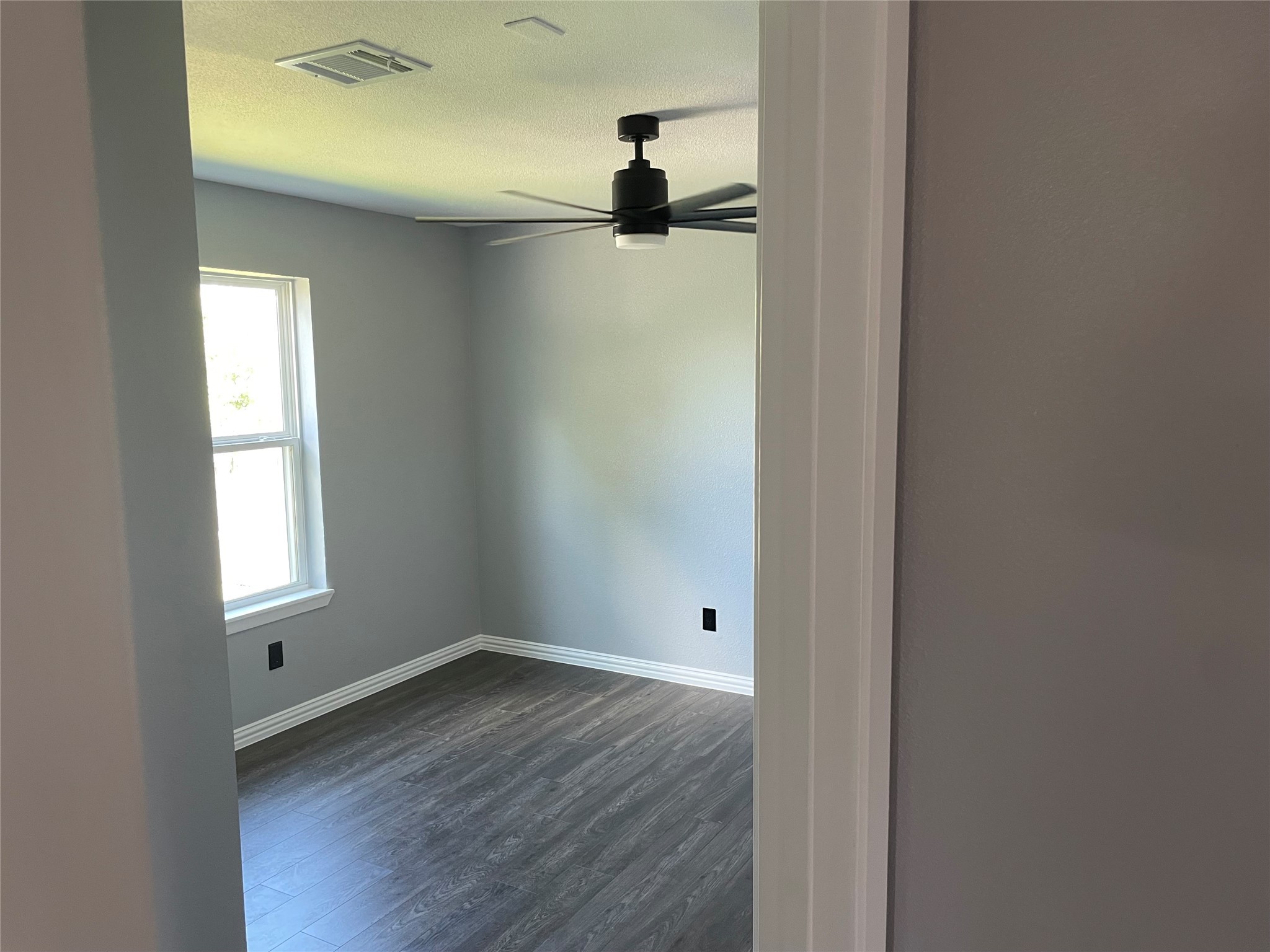 2709 Terry Street Houston, TX 77009 - Photo 13 of 23 wooden floor in an empty room with a window