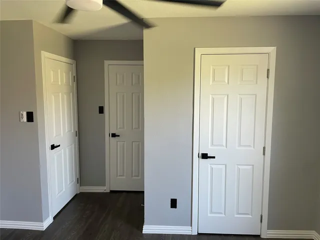 an entryway to room with wooden floor