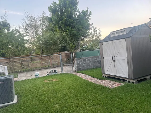 a view of a backyard with a small cabin