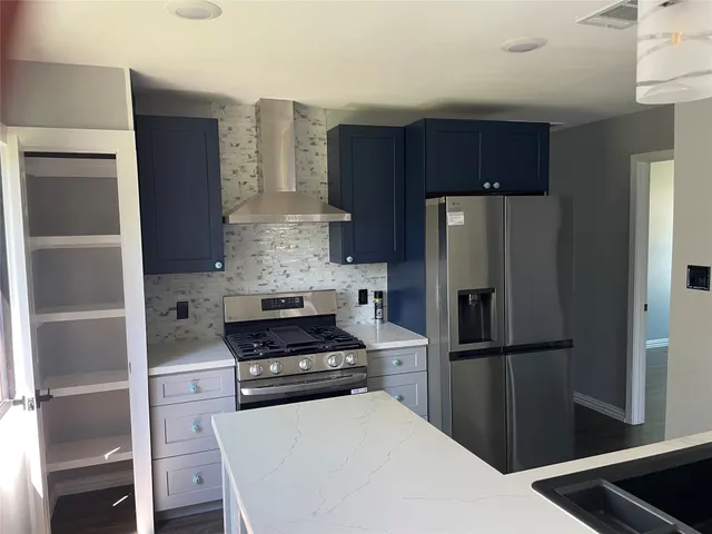 a kitchen with a refrigerator and a stove