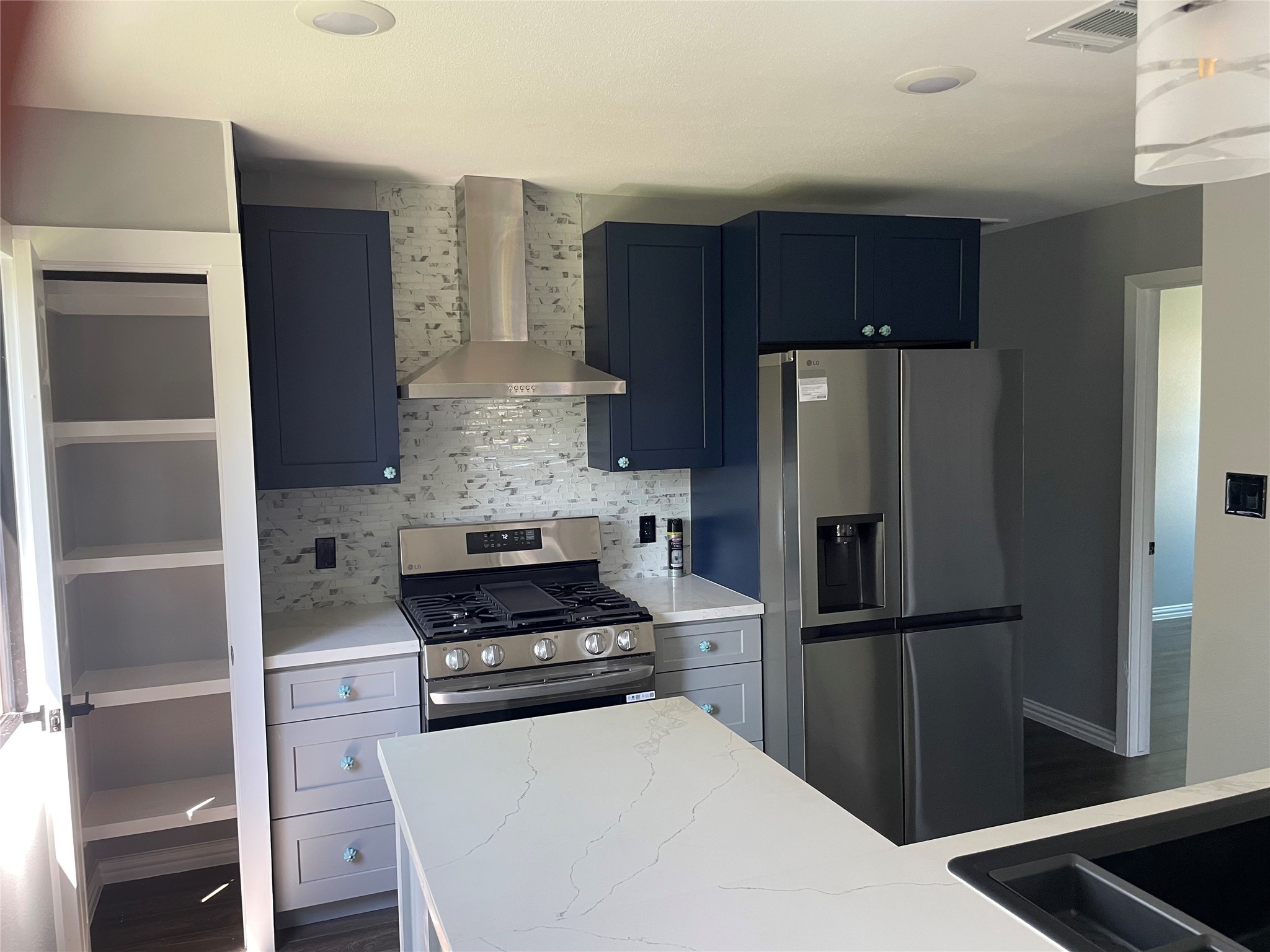 2709 Terry Street Houston, TX 77009 - Photo 7 of 23 a kitchen with a refrigerator and a stove