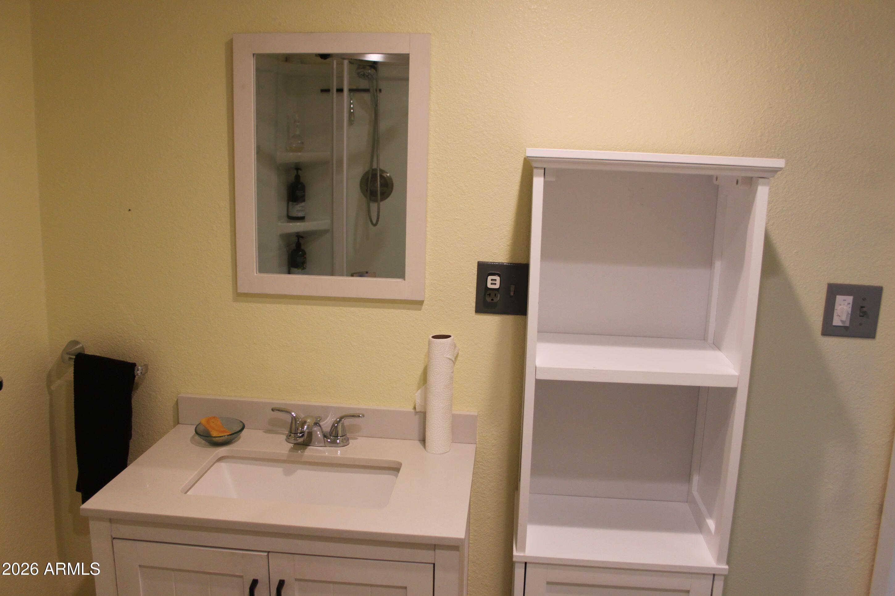 10847 South Kings Ranch Road Hereford, AZ 85615 - Photo 20 of 49 a bathroom with a sink and a mirror