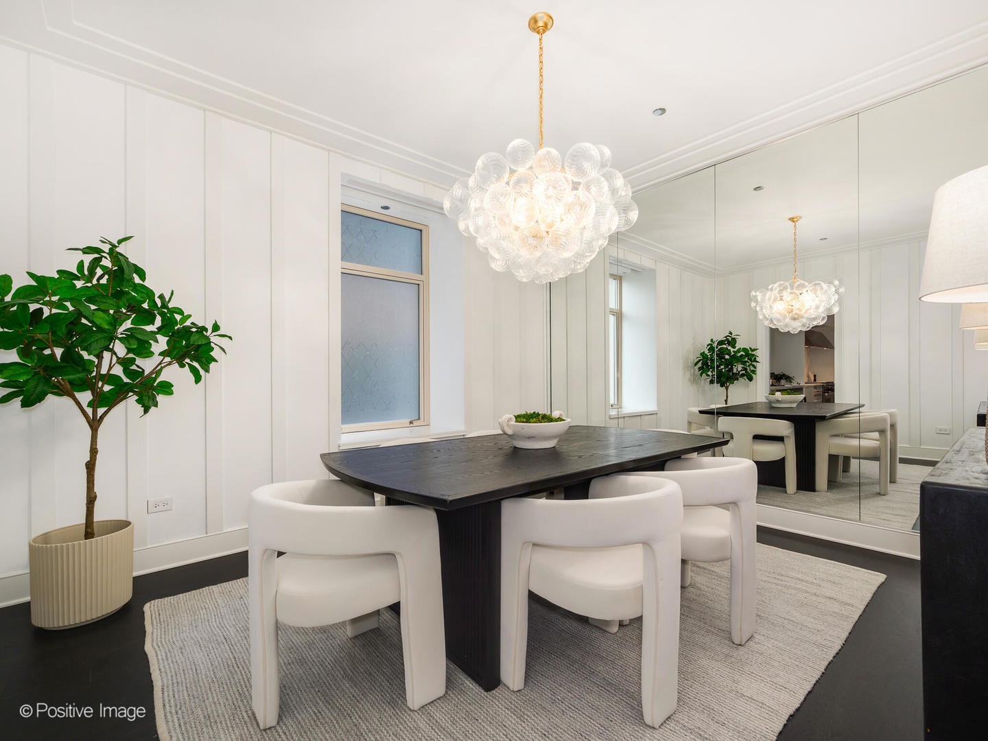 118 East Erie Street, Unit 31G Chicago, IL 60611 - Photo 16 of 54 a view of a dining room with furniture and wooden floor