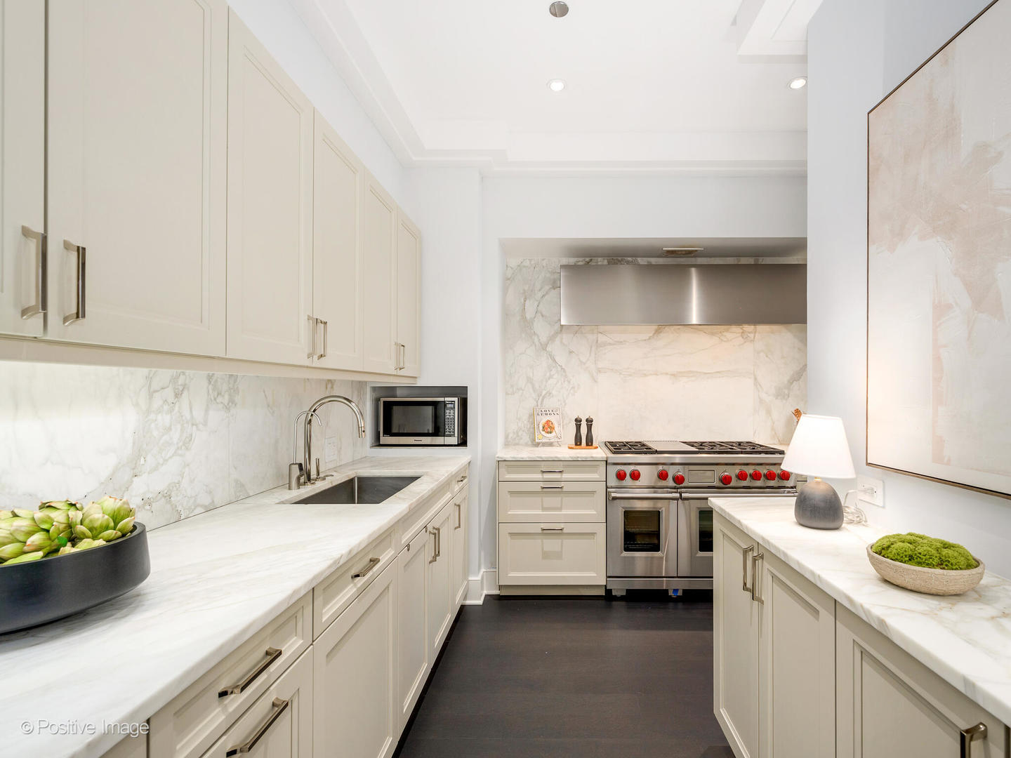 118 East Erie Street, Unit 31G Chicago, IL 60611 - Photo 21 of 54 a kitchen with a sink stove and cabinets