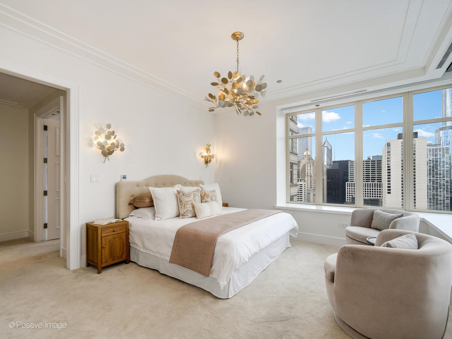 118 East Erie Street, Unit 31G Chicago, IL 60611 - Photo 25 of 54 a bedroom with bed and a chandelier