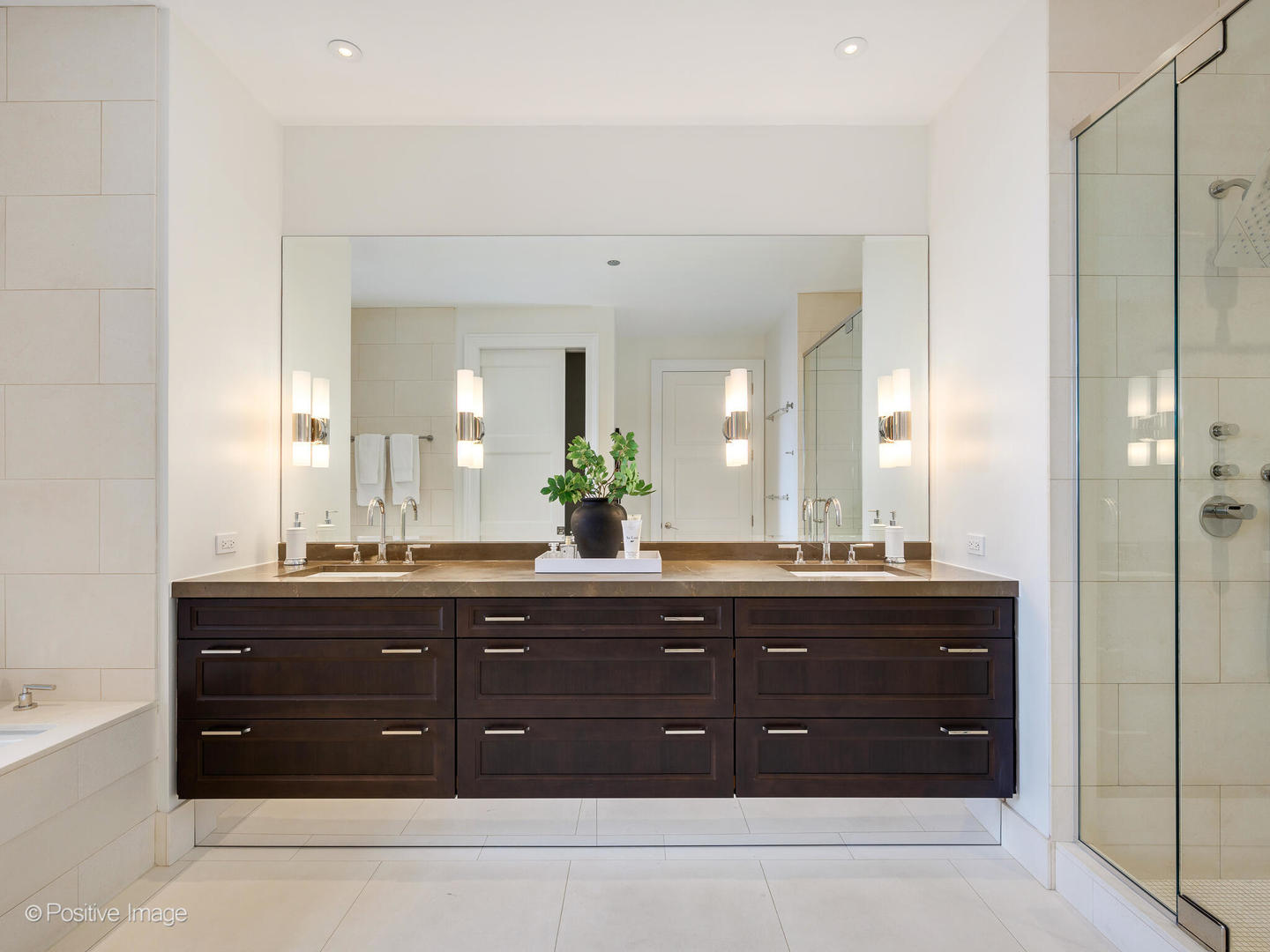 118 East Erie Street, Unit 31G Chicago, IL 60611 - Photo 28 of 54 a spacious bathroom with a granite countertop sink a mirror and a bathtub