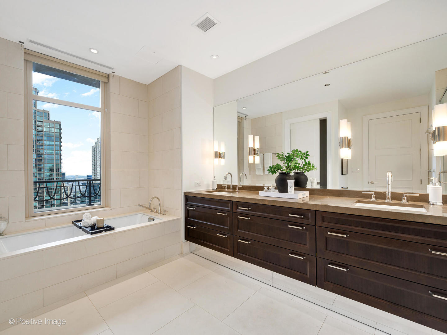 118 East Erie Street, Unit 31G Chicago, IL 60611 - Photo 29 of 54 a spacious bathroom with a tub sink and mirror