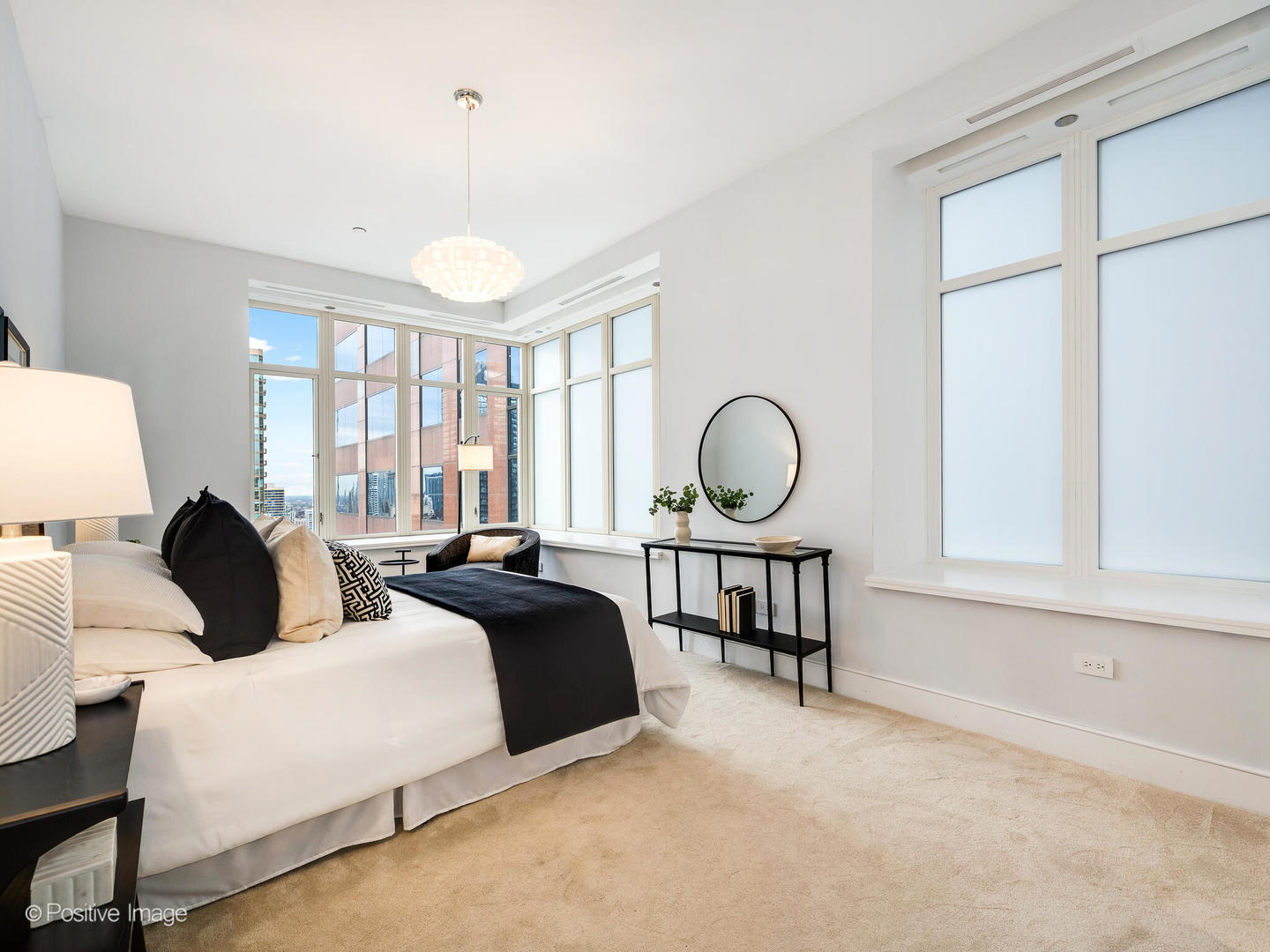 118 East Erie Street, Unit 31G Chicago, IL 60611 - Photo 32 of 54 a bedroom with bed a table and a large window