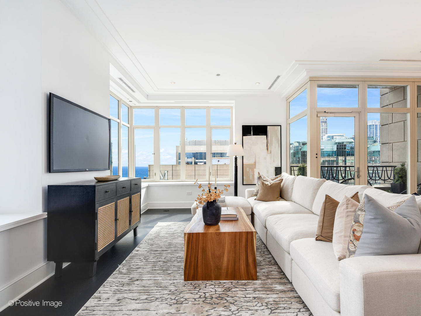 118 East Erie Street, Unit 31G Chicago, IL 60611 - Photo 9 of 54 a living room with furniture large windows and a flat screen tv