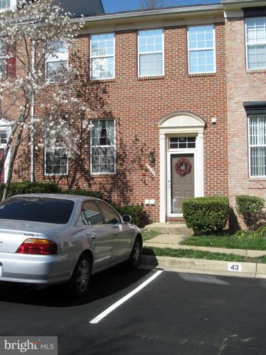 a view of a car parked in front of a brick building