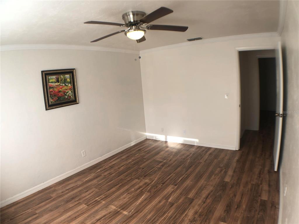 5403 Northwest 20th Court, Unit C Gainesville, FL 32653 - Photo 11 of 21 a view of empty room with wooden floor