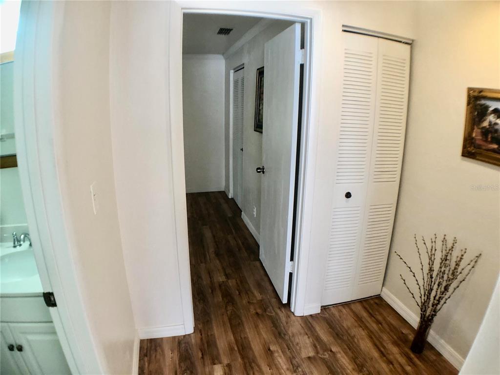 5403 Northwest 20th Court, Unit C Gainesville, FL 32653 - Photo 12 of 21 a view of a hallway with wooden floor and staircase