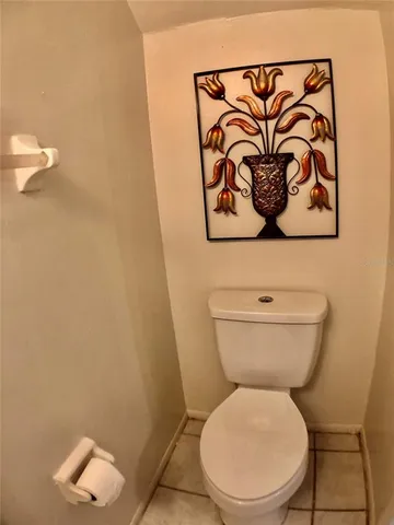 a white toilet sitting next to a white wall