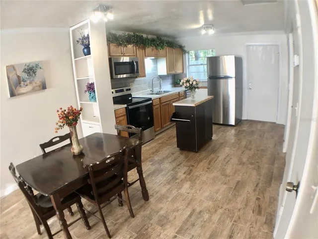 a kitchen with refrigerator cabinets dining table and chairs