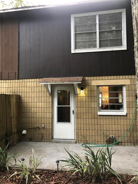 5403 Northwest 20th Court, Unit C Gainesville, FL 32653 - Photo 21 of 21 a view of a brick house with many windows