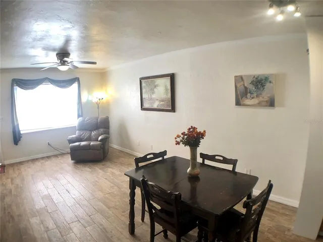 a view of a dining room with furniture and wooden floor