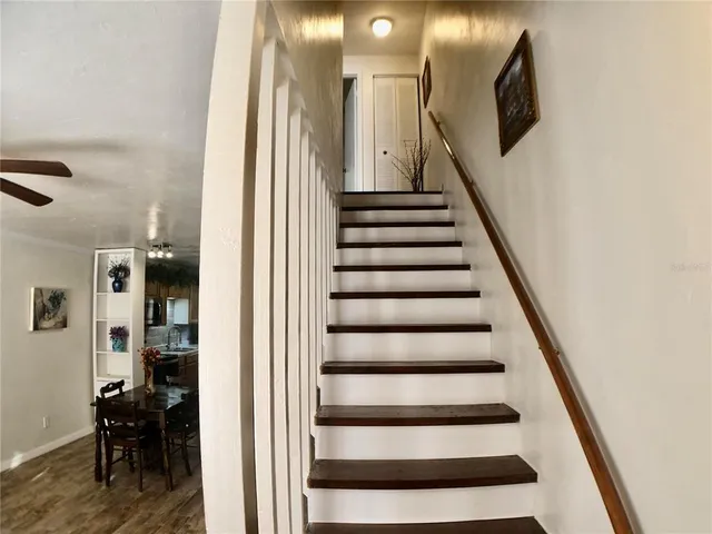 a view of entryway and hall with wooden floor