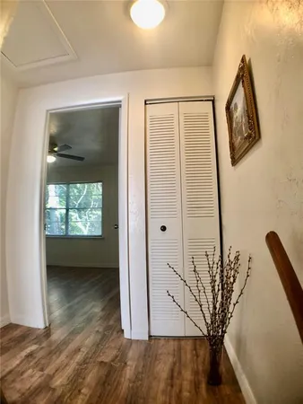a view of a livingroom with wooden floor and a ceiling fan