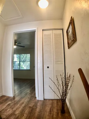 a view of a livingroom with wooden floor and a ceiling fan