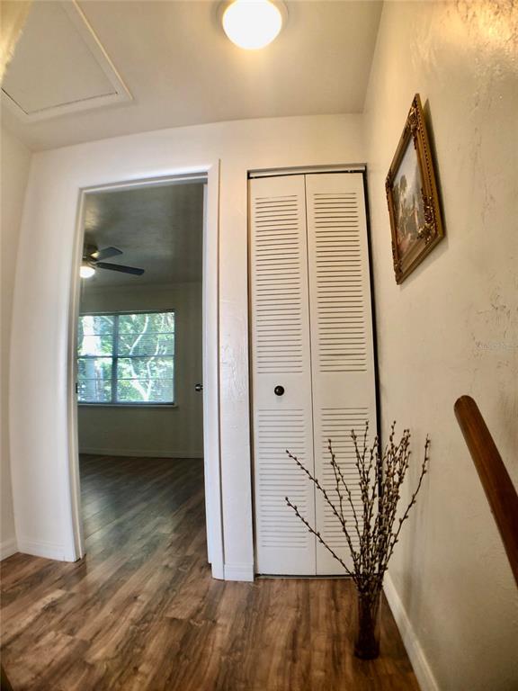 5403 Northwest 20th Court, Unit C Gainesville, FL 32653 - Photo 8 of 21 a view of a livingroom with wooden floor and a ceiling fan