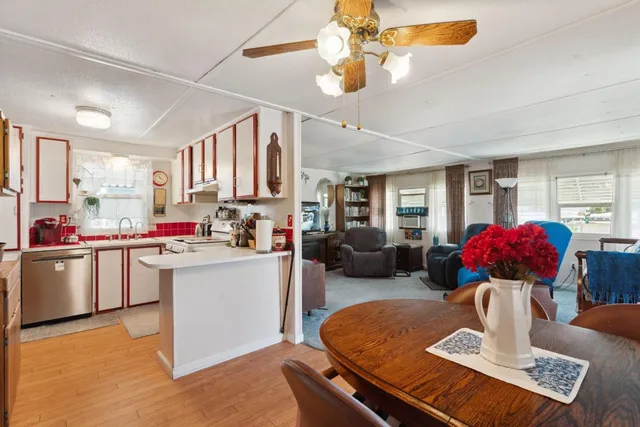 a living room with kitchen island furniture and a chandelier