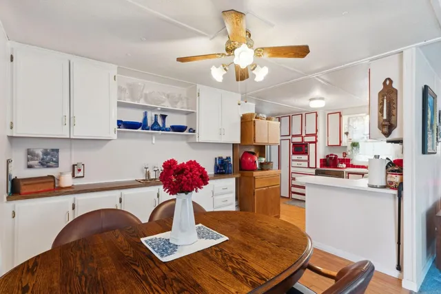 a kitchen with stainless steel appliances kitchen island granite countertop a sink dishwasher and cabinets with wooden floor