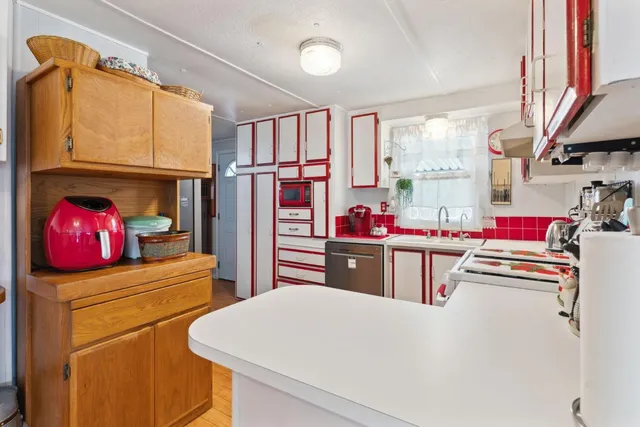 a living room with stainless steel appliances kitchen island granite countertop furniture and a dining table