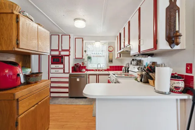 a kitchen with stove and cabinets