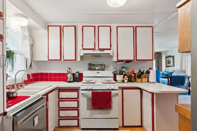 a kitchen with stainless steel appliances granite countertop a sink stove and cabinets