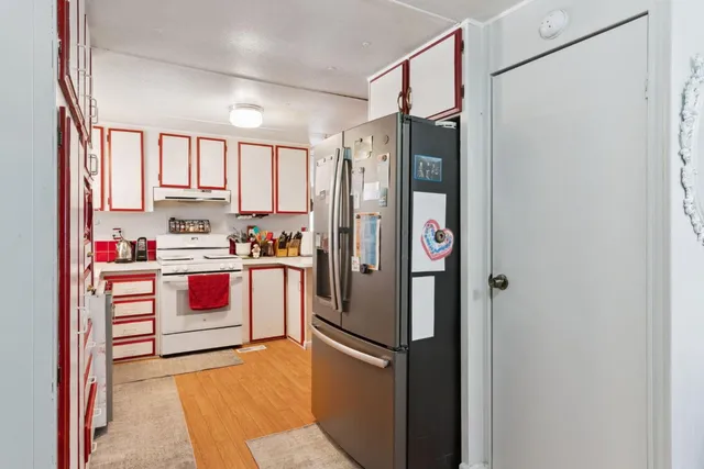 a kitchen with stainless steel appliances a refrigerator sink and cabinets