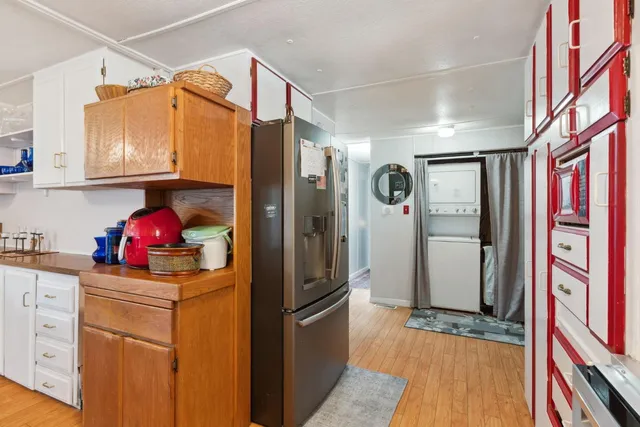 a kitchen with a refrigerator sink and cabinets