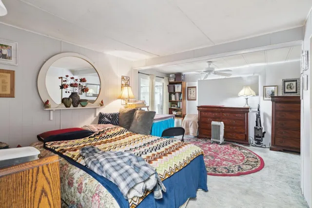 a bedroom with a bed and a fireplace