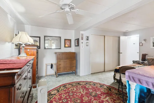 a bed room with a bed furniture and a flat screen tv