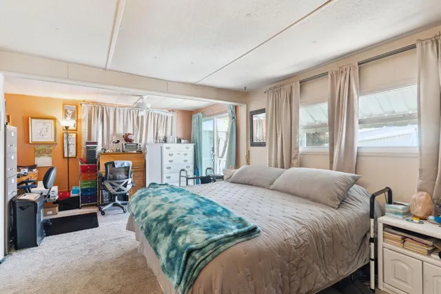 a bedroom with a large bed and a large window