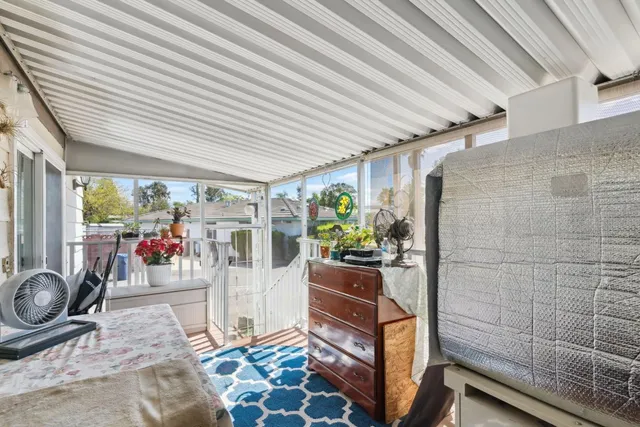 a balcony with furniture and a potted plant