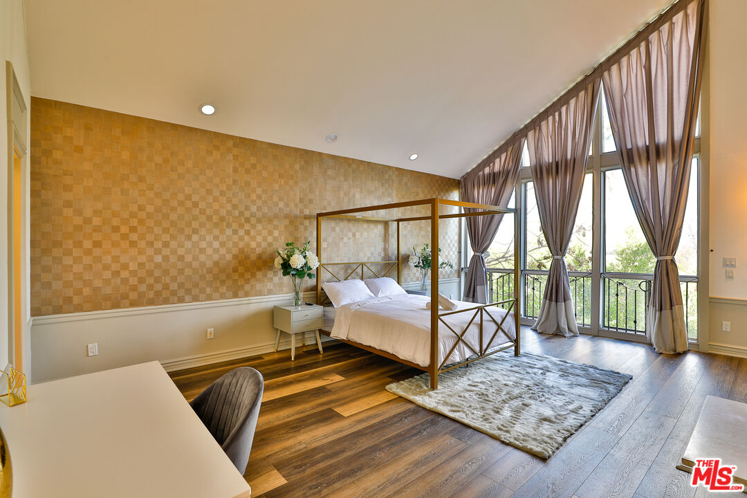 14839 Valley Vista Boulevard Sherman Oaks, CA 91403 - Photo 13 of 65 a bedroom with furniture and a wooden floor