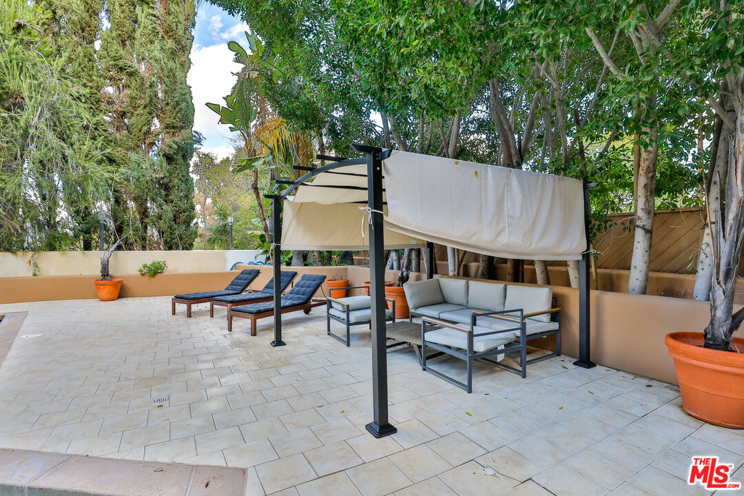 14839 Valley Vista Boulevard Sherman Oaks, CA 91403 - Photo 15 of 65 an outdoor sitting area with couch and wooden fence