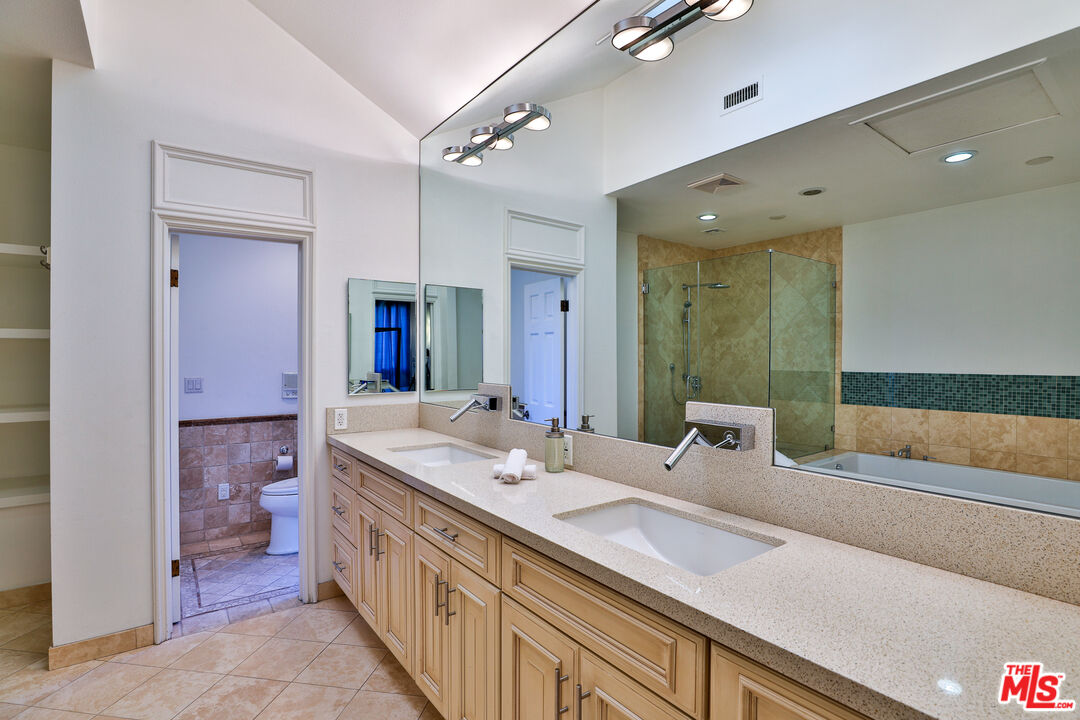 14839 Valley Vista Boulevard Sherman Oaks, CA 91403 - Photo 20 of 65 a bathroom with a double vanity sink and a mirror