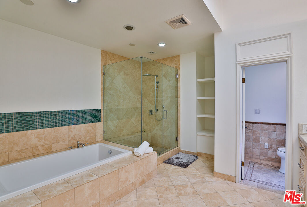 14839 Valley Vista Boulevard Sherman Oaks, CA 91403 - Photo 22 of 65 a bathroom with a bathtub and a shower
