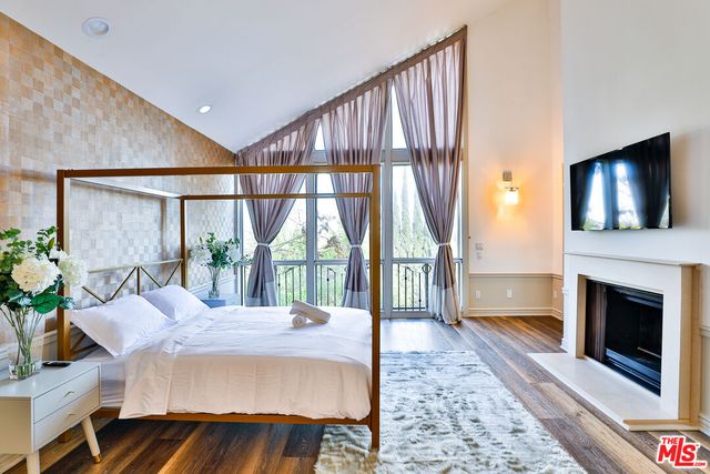 a bedroom with two beds and a lamp