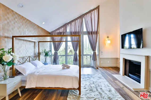 a bedroom with two beds and a lamp