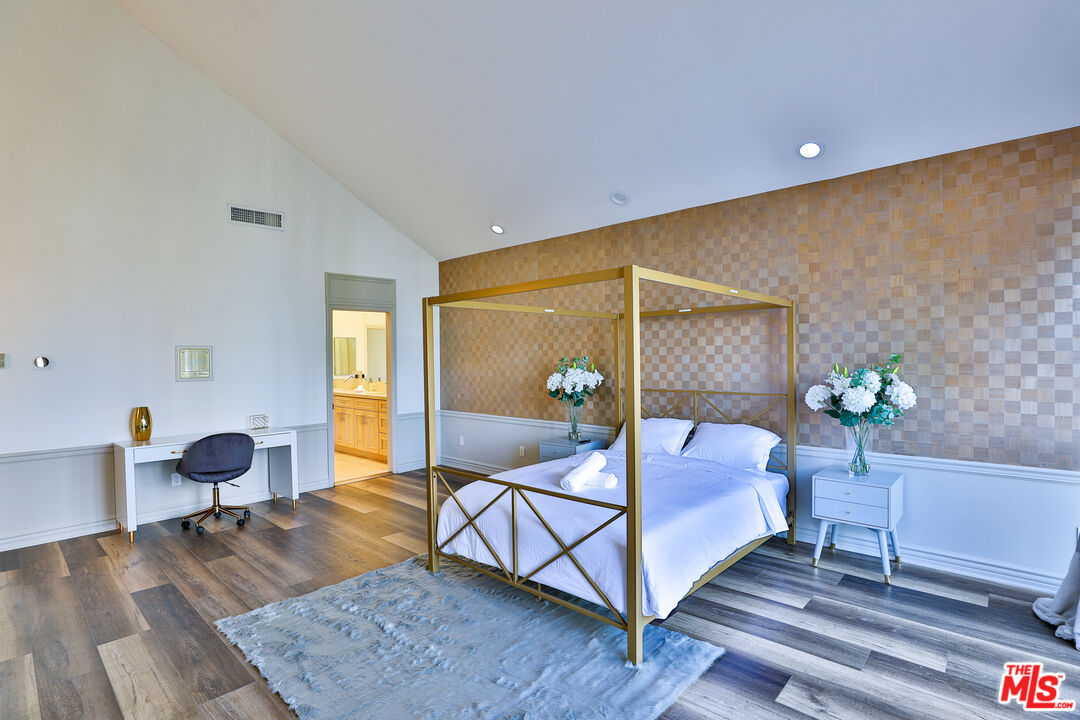 14839 Valley Vista Boulevard Sherman Oaks, CA 91403 - Photo 32 of 65 a bedroom with a bed and wooden floor