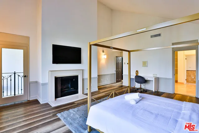 a living room with fireplace furniture and a flat screen tv