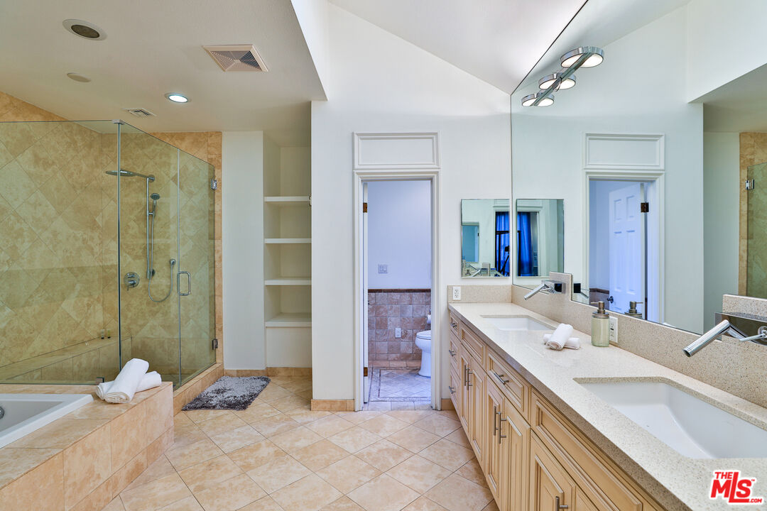 14839 Valley Vista Boulevard Sherman Oaks, CA 91403 - Photo 36 of 65 a spacious bathroom with a double vanity sink mirror and shower