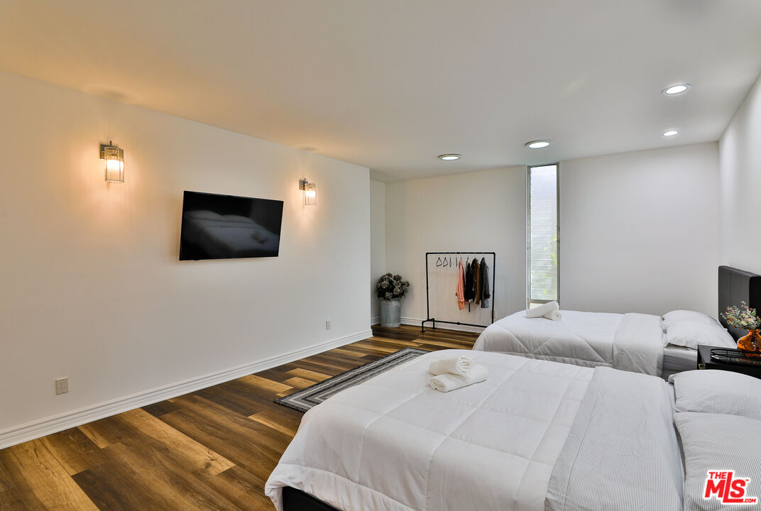 14839 Valley Vista Boulevard Sherman Oaks, CA 91403 - Photo 37 of 65 a bedroom with a bed and a flat screen tv