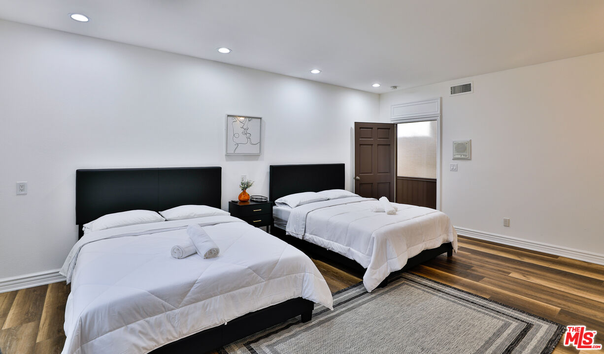 14839 Valley Vista Boulevard Sherman Oaks, CA 91403 - Photo 38 of 65 a bedroom with two beds and a lamp